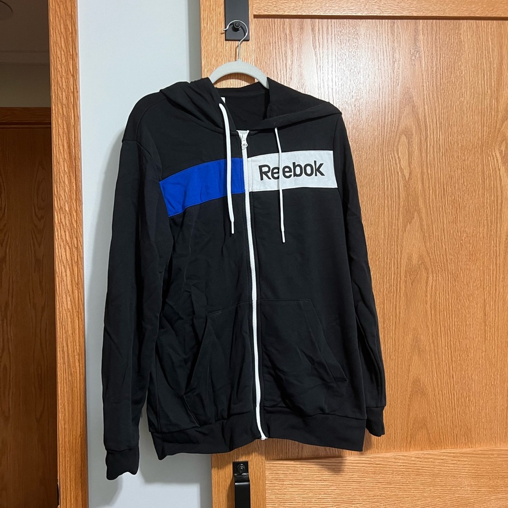 Reebok zip up hoodie in black. Size medium.